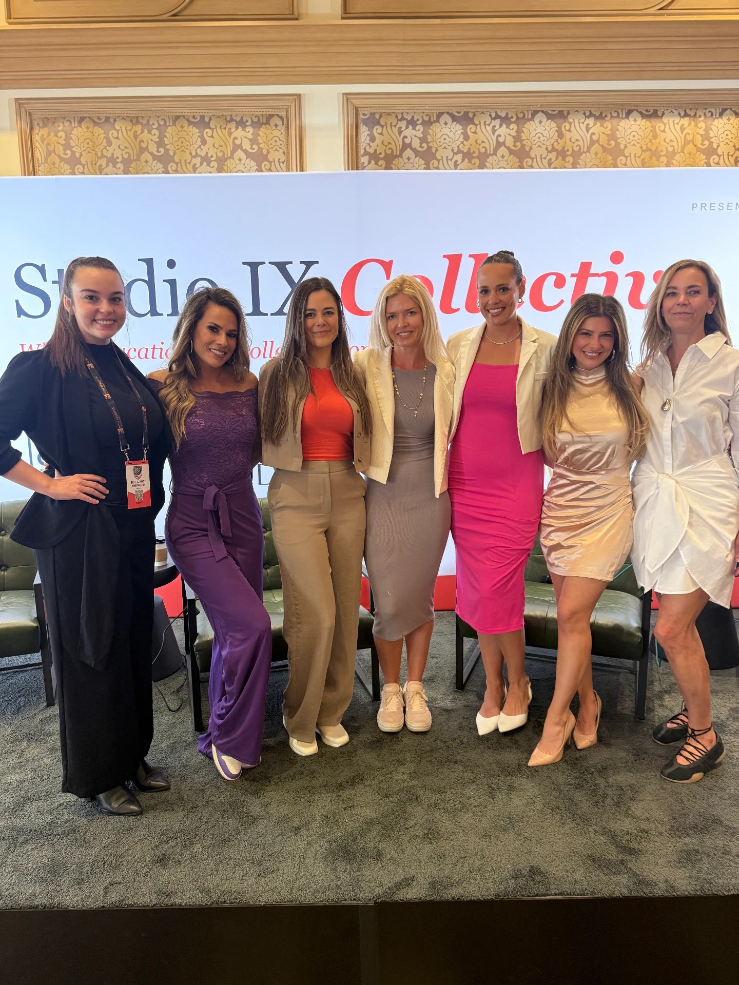 Studio IX Collective panelists on stage in front of the branded backdrop